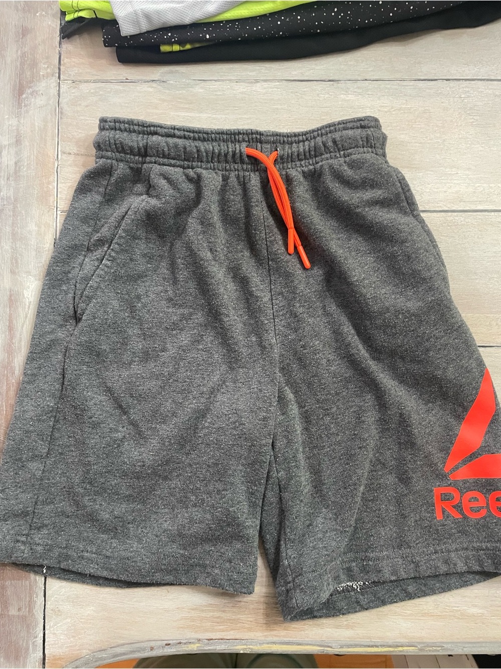 Reebok Gray Athletic Shorts with Orange Drawstring and Logo
